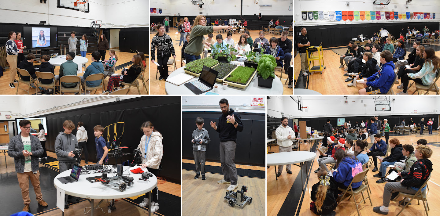 students visiting different tables in gym